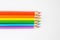 Top view of colored wooden pencils, forming colors of the LGBTI flag isolated on a white background