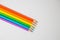 Top view of colored wooden pencils, forming colors of the LGBTI flag isolated on a white background