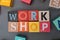 Top view of colorful cubes spelled "workshop", a webinar coaching workshop