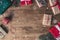 Top view of colorful decorated gift boxes on a wooden table with falling snow effect