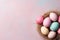 Top view of Colorful easter eggs in nest on pink background. Easter background with copy space