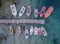 A top view of colorful fishing boats anchoring in marina next to jetty wooden pier
