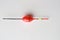 Top view of a colorful fishing rod bobber on a white background
