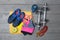 Top view of colorful fitness equipment on wooden floor