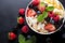 Top view of a colorful oat granola bowl with fresh fruits