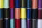 Top view of colorful spool of thread as a background.Rows of bobbins