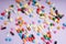 Top view - colourful medicine pills over pastel background