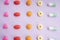 Top view - colourful medicine pills over pastel background
