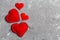 Top view composition of red hearts on cement background. Romantic relationship concept. Valentaine`s Day