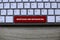 Top view of computer keyboard with red key written with Mortgage and Refinancing on wooden background