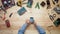 Top view computer technician using smart phone with circuit board outline at wooden desk with tools and electronic