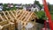 Top view of construction of wooden houses. Clip. Process of construction of country wooden house on background of