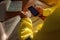 Top view of construction worker setting on the chair holding cell phone and writing emergency site phone number