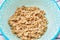 top view of cooked oatmeal in a blue plate with a pattern, healthy breakfast