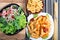 Top view of cooked rigatoni pasta and fresh salad