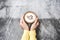 Top view with copy space. Hand women holding coffee love on cement table, vintage tone.