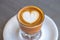 Top view of cortado coffee in a glass with the foam in shape of heart