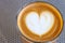 Top view of cortado coffee in a glass with the foam in shape of heart