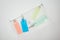 Top view of cosmetic bag with colorful bottles with liquids on white background.