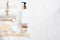 Top view of Cosmetic bottles, soap, wooden spoon and towel on white marble