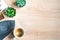 Top view of cosy home scene. Books, woolen blanket, cup of coffee and succulent plants over wooden background. Copy space