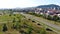 Top view of country cottages with red roofs on background of mountains. Clip. Expensive cottages with red roofs arranged