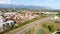 Top view of country cottages with red roofs on background of mountains. Clip. Expensive cottages with red roofs arranged