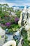 Top view of the courtyard with flowers and a tree near the building with an amazing facade