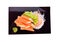 top view crab sticks with wasabi on black plate and on white background