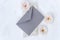 Top view of craft envelope, beautiful delicate roses, piece of marble on the white background