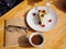 Top view of a creamy cupcake with cofee on the wooden table. Food concept.