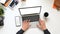 Top view Creative man`s hands typing on computer laptop with white blank screen.