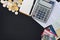 Top view of credit cards, passbooks saving account, calculator, notepad with pen and pile of coins on black background