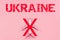 Top view of a crossed out toy plane on a pink background with the inscription UKRAINE. Ban on flights over the state