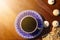 Top view of cup of black morning coffee and cookies with sunflower seeds on dark wooden table. Flat lay