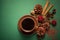 Top view on cup of coffee with cinnamon and pinecone