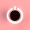 Top view of a cup of coffee in the form of power isolated on pink background