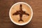 top view of cup of coffee with plane sign on wooden tabletop