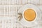 Top view of a cup of expresso with cookies on a bright wooden ta