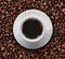 Top view of cup of hot coffee on roast coffee bean. Bird eyes view of coffee cup on raw coffee beans.
