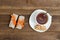 Top view on cup of tea and few bar of muesli. Brown wooden background