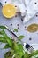 A top view of cut lemon on a grease-proof paper next to a tableware. Dinner composition on a gray background.