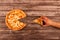 Top view on cut into slices big delisious four-cheese pizza and man`s hand taking one slice, on wooden background or table with