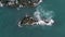 Top view of cute and heavy sea lions lying, crawling or resting on rocky rookery or breakwater surrounded by sea or