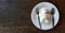 Top view of cute teddy bear shape made from white rice with spoon and fork on dish or plate on brown wooden table and copy space