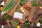 Top view of cutting boards, cherry tomatoes, salt, garlics, cucumbers, chili peppers, pepper mill, meat chopper, lemons