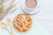 Top view danish pastries and coffee cup on white wooden table