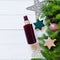 Top view of dark brown spray bottle mock-up, fir branches, decorations, stars, balls on a shabby white board wooden table. Blank