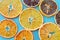 Top view of dehydrated citrus fruits as lemons, tangerines, oranges on blue background