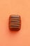 Top view of delicious Belgium chocolate on an orange background
